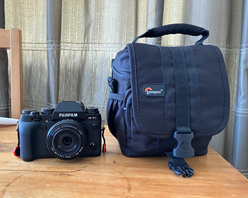 Lowepro adventura 120 shoulder bag next to a Fuji X-T1.