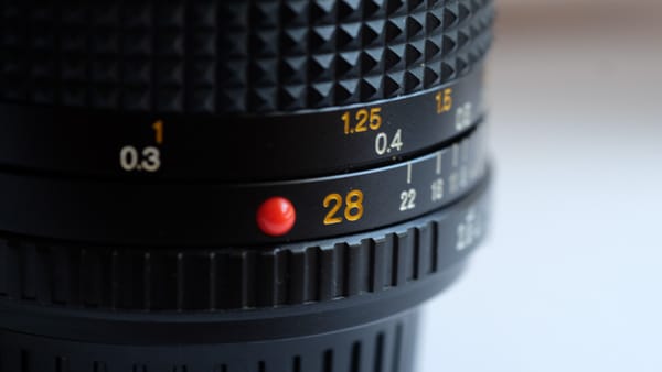 Close up image of a Minolta 28mm MD lens.